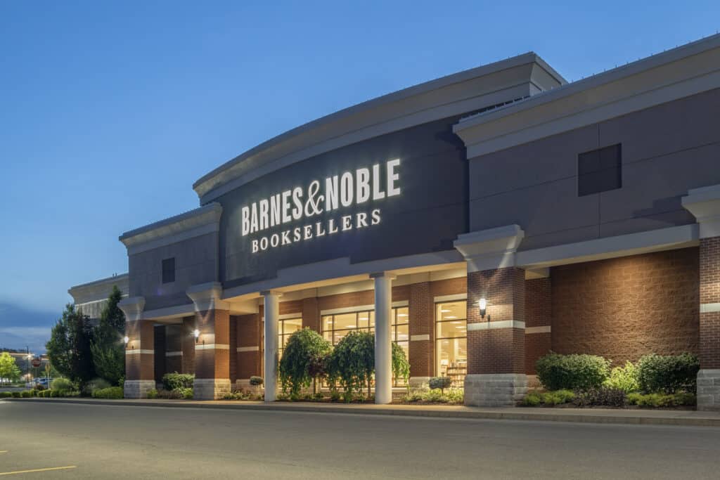 New Hartford, New York - Aug 18, 2019: Barnes and Noble Booksellers store at dusk, with the store logo illuminated against a deep blue sky